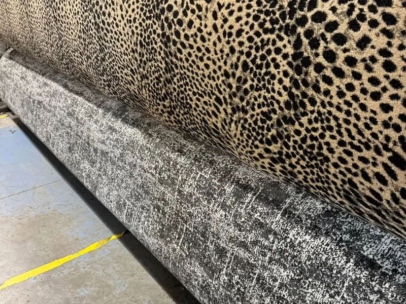 Leopard-pattern carpet rolls in neutral colours at Farrells.