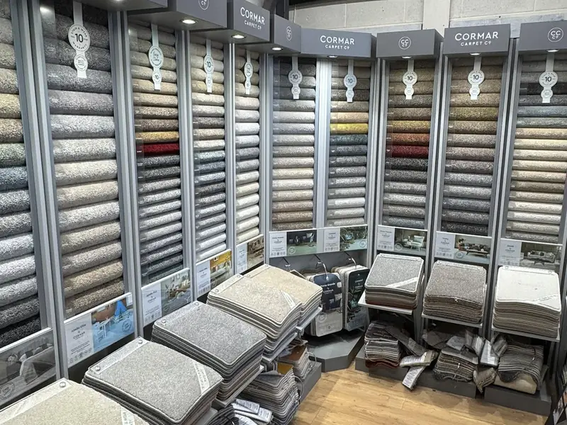 A wide view of carpet and flooring sample stands in the Farrells showroom.