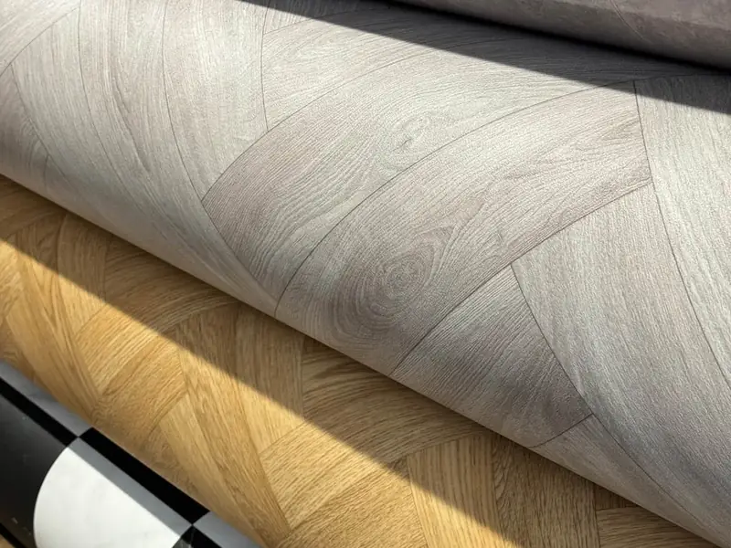 Wood-effect and herringbone-pattern vinyl rolls at Farrells.